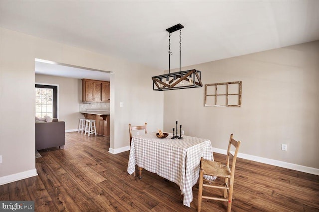 dining area with dark hardwood / wood-style flooring