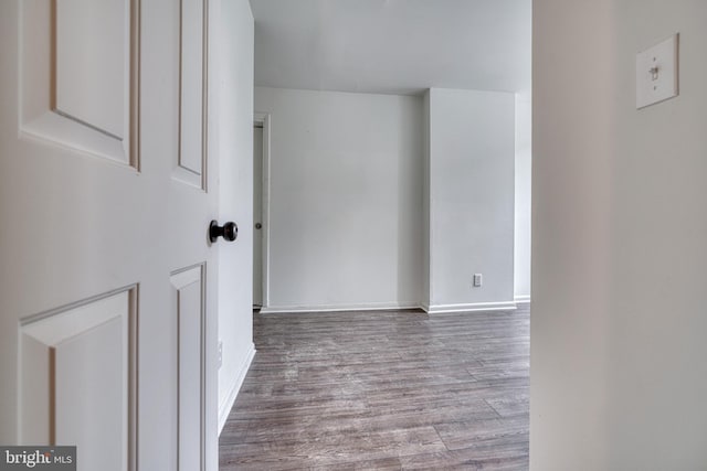 empty room featuring wood finished floors and baseboards