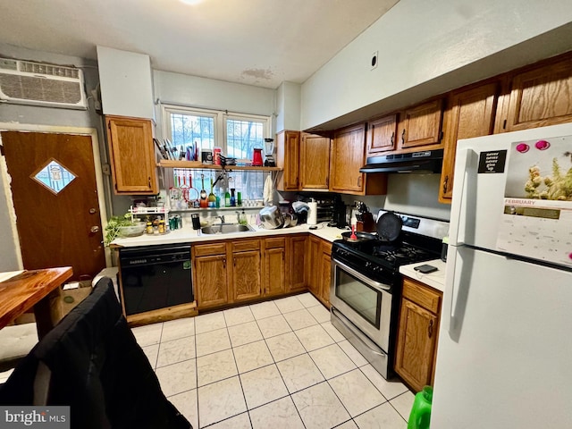 kitchen with dishwasher, sink, white refrigerator, gas stove, and a wall unit AC