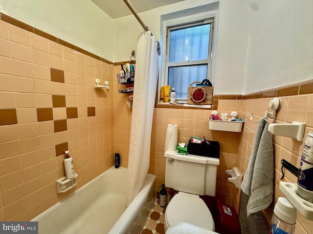 bathroom with shower / bath combo, tile walls, and toilet