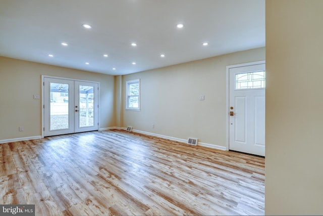 interior space with light hardwood / wood-style floors and french doors