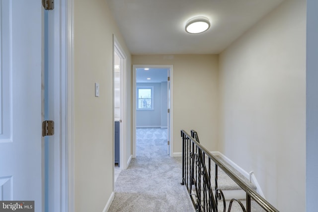 hallway with light colored carpet