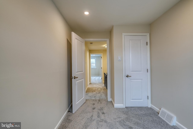 corridor with light carpet