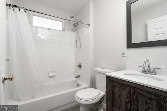 bathroom featuring vanity, shower / bath combo with shower curtain, and toilet