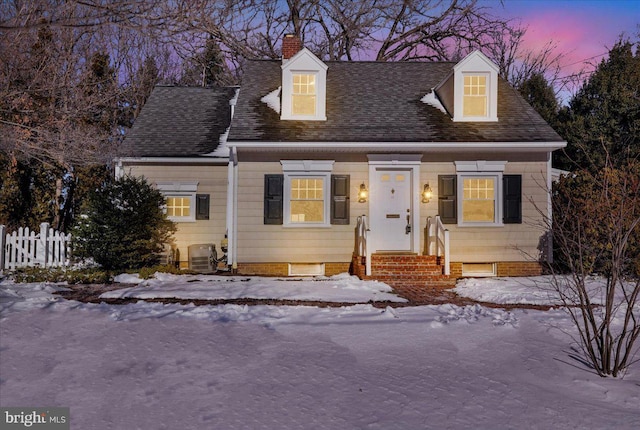 cape cod-style house featuring central air condition unit