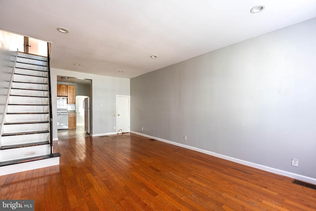 unfurnished living room with dark hardwood / wood-style floors