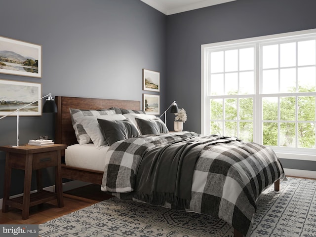 bedroom featuring hardwood / wood-style floors and crown molding