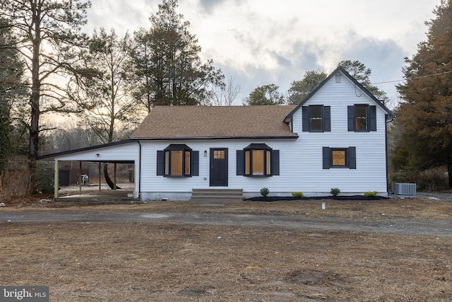 view of front of home featuring a carport and central air condition unit