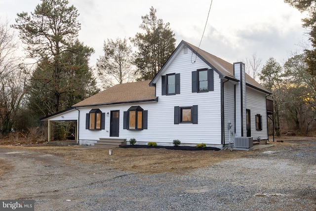 view of front of house featuring central AC and a carport