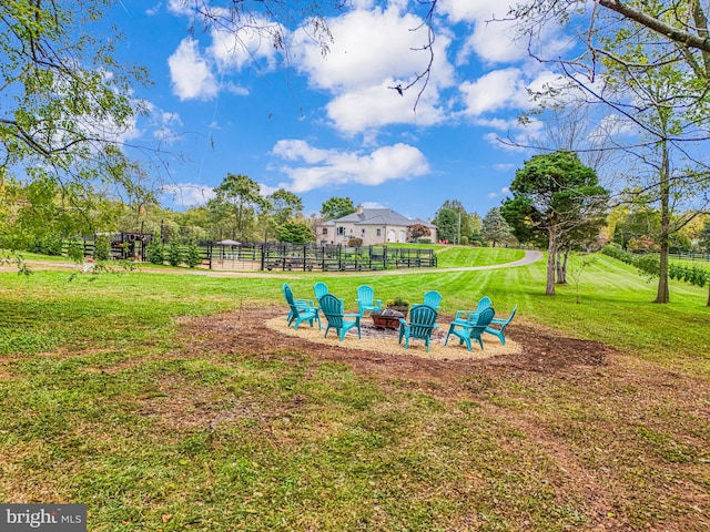 view of yard featuring an outdoor fire pit and fence