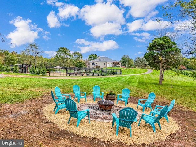 view of yard with fence and a fire pit