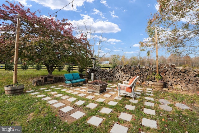 view of yard featuring a patio area and a fire pit