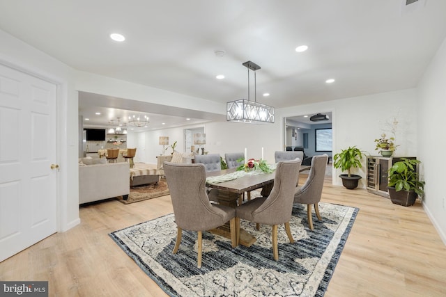 dining room with light wood-type flooring, baseboards, and recessed lighting