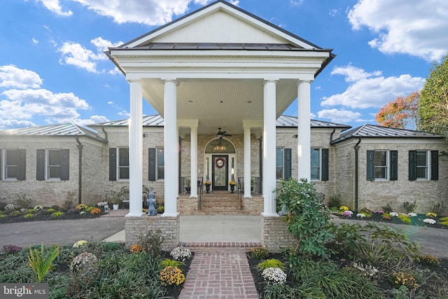 entrance to property with a standing seam roof, brick siding, and metal roof