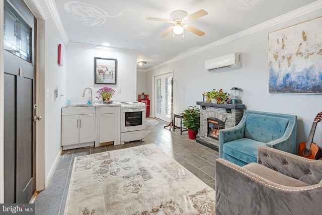 interior space with french doors, crown molding, an AC wall unit, a stone fireplace, and baseboards