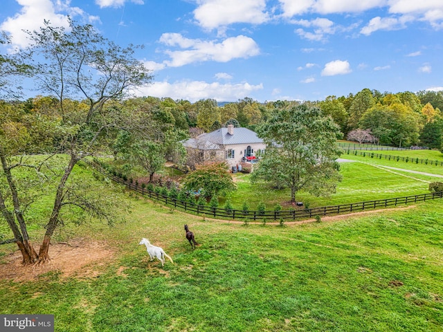 view of yard with a rural view and fence