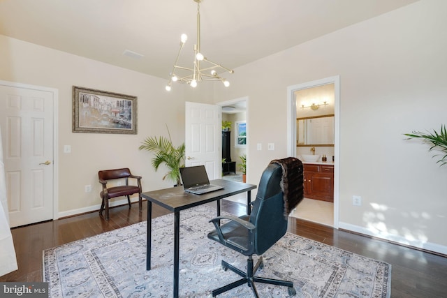 office area featuring dark wood-style floors, a chandelier, and baseboards