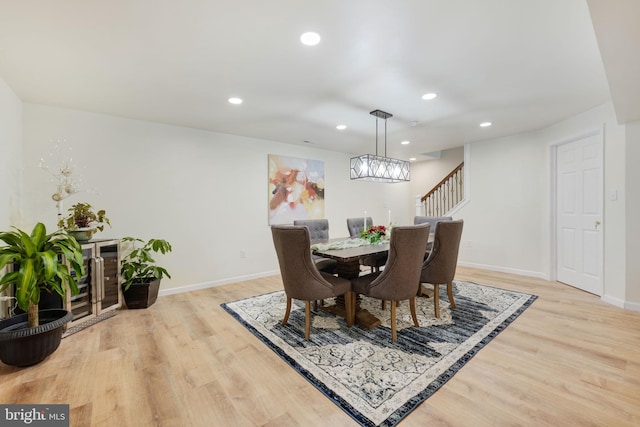 dining room with baseboards, recessed lighting, and light wood-style floors