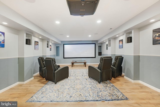 home theater featuring baseboards, wood finished floors, and recessed lighting