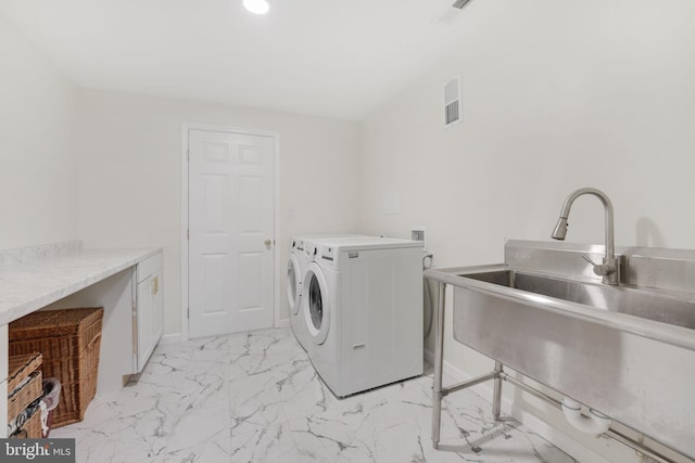 laundry area featuring laundry area, a sink, visible vents, marble finish floor, and washing machine and clothes dryer