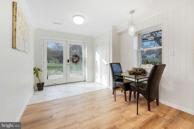 dining space with a healthy amount of sunlight, visible vents, and wood finished floors