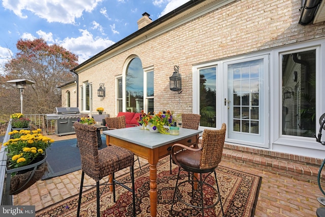 view of patio / terrace featuring outdoor dining area and grilling area