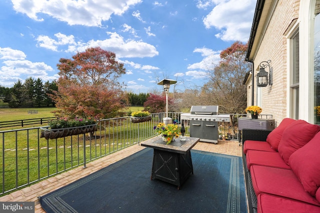 view of patio with a balcony, a grill, and outdoor lounge area