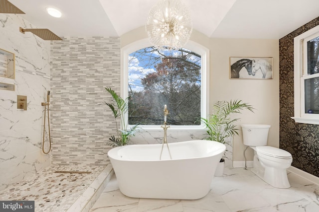 bathroom with a chandelier, a freestanding tub, toilet, marble finish floor, and tiled shower