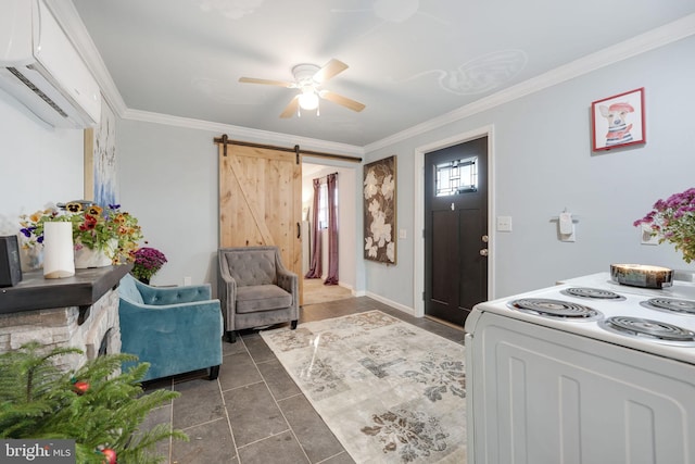 entryway with a barn door, ornamental molding, a ceiling fan, a wall mounted air conditioner, and baseboards