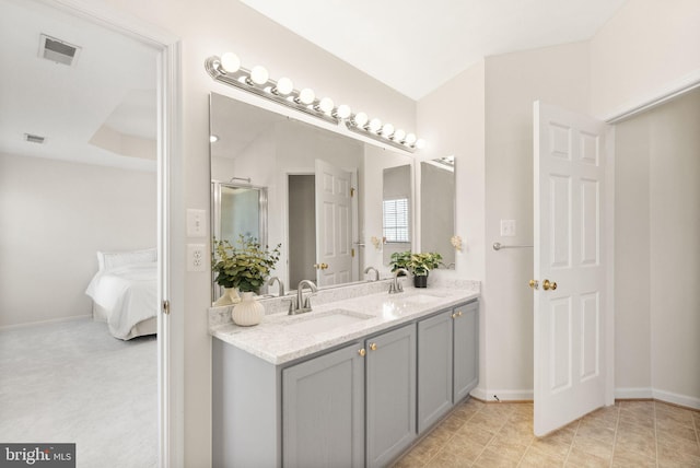 ensuite bathroom with double vanity, visible vents, a sink, and ensuite bathroom