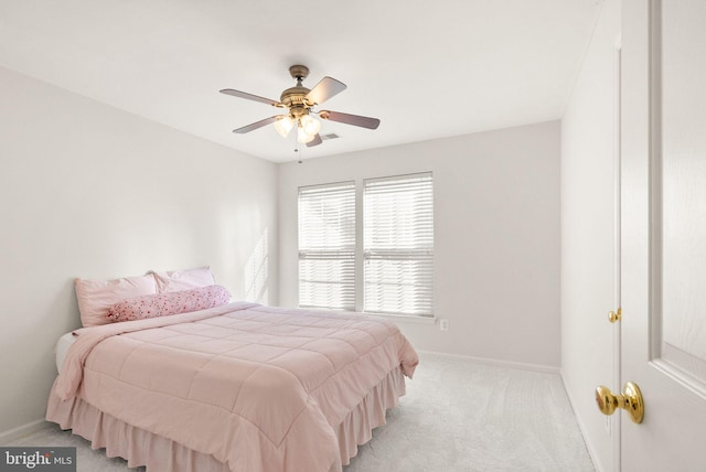 bedroom featuring light carpet, ceiling fan, visible vents, and baseboards