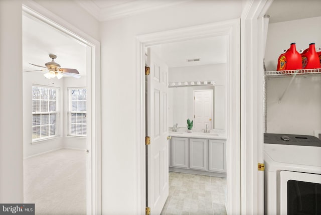 washroom featuring a sink, laundry area, visible vents, and a ceiling fan