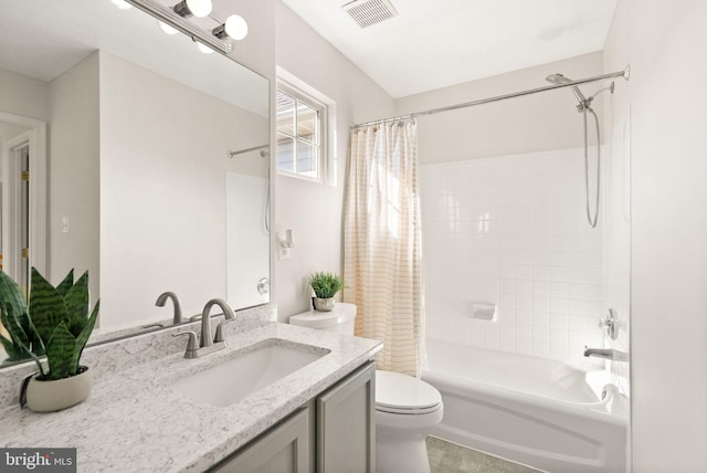 bathroom featuring shower / bath combo, visible vents, vanity, and toilet