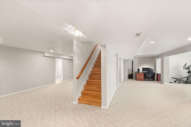 finished below grade area featuring light carpet, baseboards, visible vents, and recessed lighting