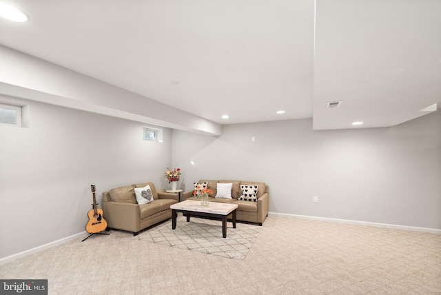 living area with baseboards, visible vents, and recessed lighting