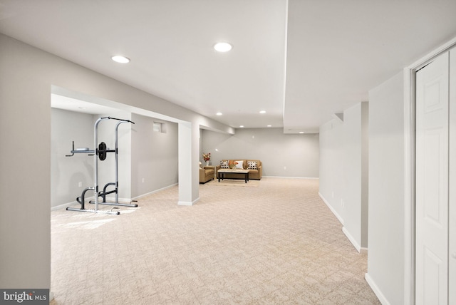 workout area featuring baseboards, light carpet, and recessed lighting