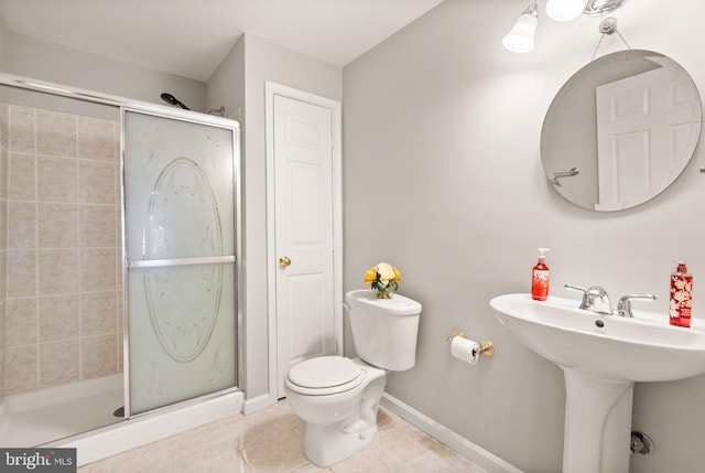 full bath with baseboards, a stall shower, toilet, and tile patterned floors