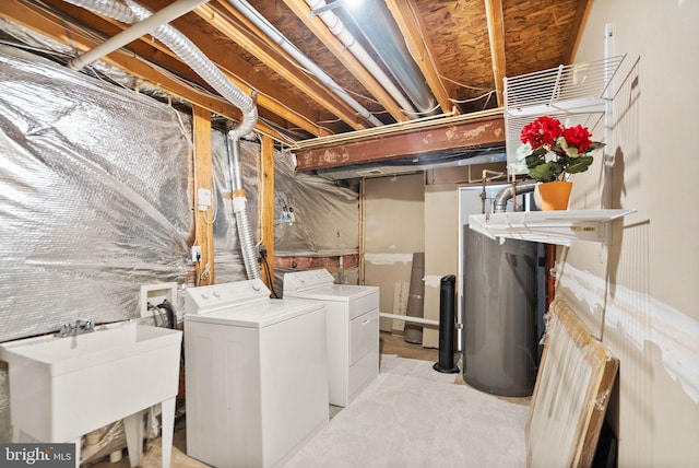 laundry room featuring laundry area, washer and clothes dryer, and a sink