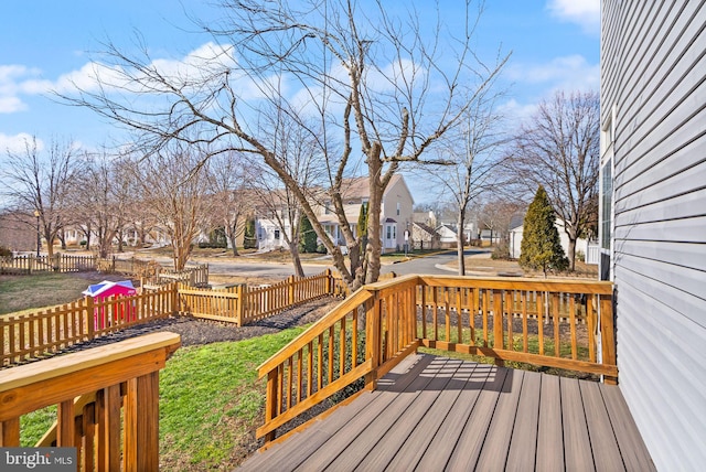 wooden terrace featuring fence and a residential view