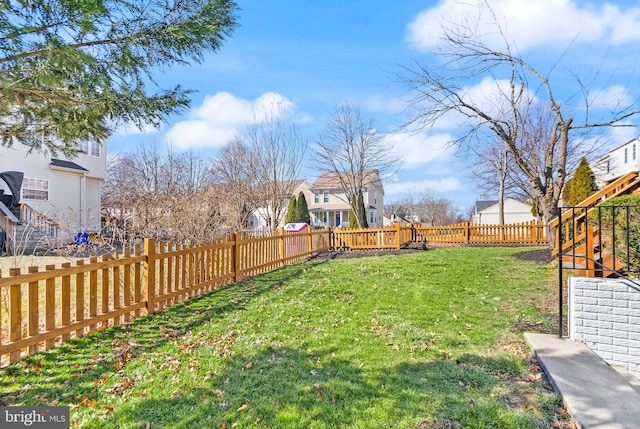 view of yard with a fenced backyard and a residential view