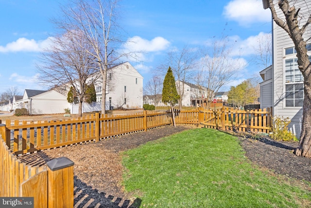 view of yard with a residential view and a fenced backyard