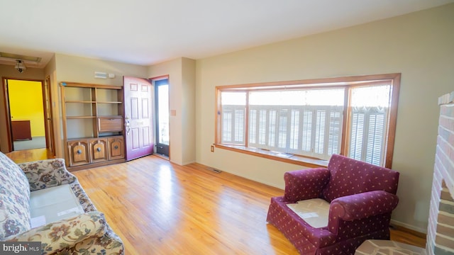 living room with visible vents and wood finished floors