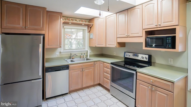 kitchen featuring a sink, appliances with stainless steel finishes, light brown cabinetry, and light countertops