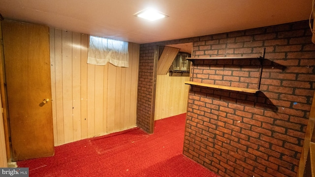 finished basement featuring wooden walls and carpet