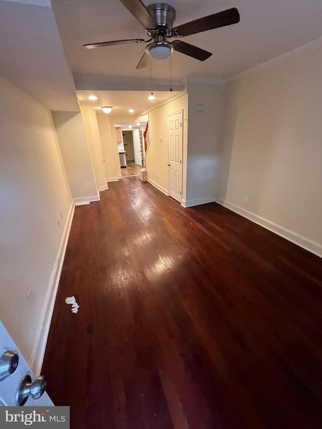 unfurnished living room featuring ceiling fan, crown molding, and dark hardwood / wood-style floors