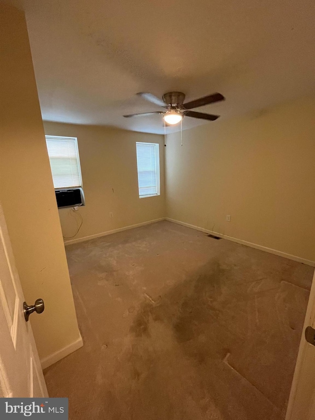 empty room featuring ceiling fan and cooling unit