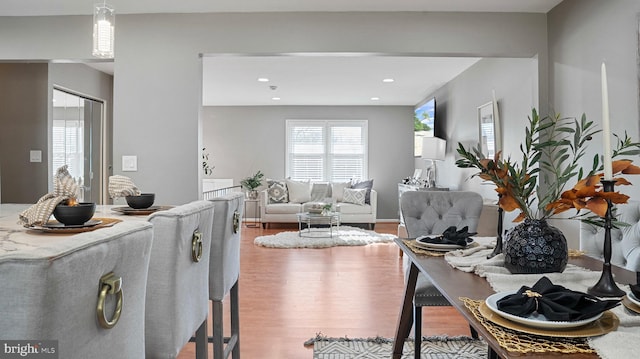 living area with recessed lighting and wood finished floors