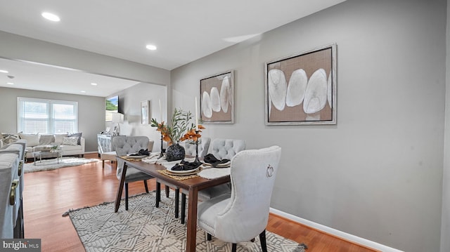 dining space featuring recessed lighting, baseboards, and wood finished floors