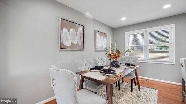 dining space with recessed lighting, baseboards, and light wood finished floors