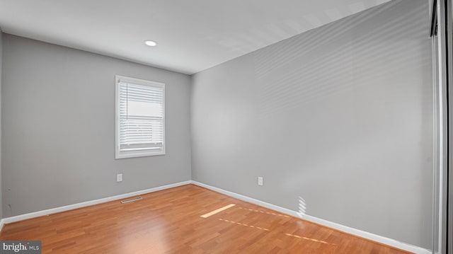 spare room with light wood-style flooring and baseboards